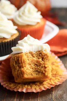 cupcakes with white frosting on paper plates