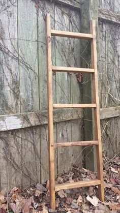 an old wooden ladder leaning against a wall