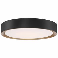 a black and gold ceiling light with an oval design on the bottom, which is lit up