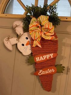 a door hanger decorated with an easter bunny and carrot