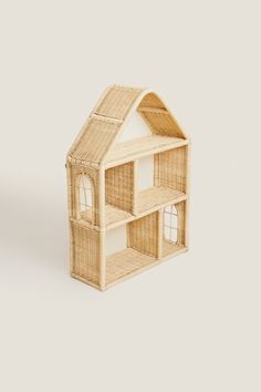 a doll house made out of wicker with windows and doors on the front side