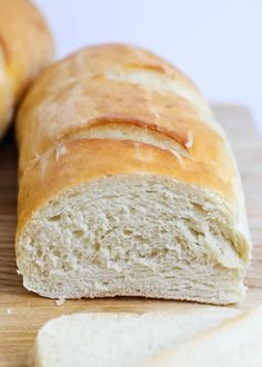 a loaf of bread sitting on top of a wooden cutting board