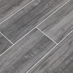 a tile floor with grey and white lines on the top, in an angle view