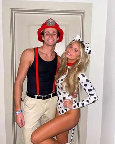 a man and woman dressed up as dalmatian and fireman for halloween costumes