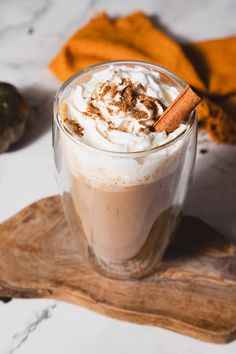 a glass cup filled with whipped cream and cinnamon