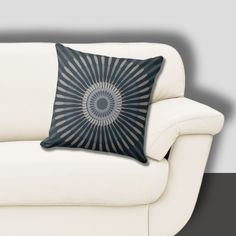 a white couch with a black and grey pillow on it's backrests