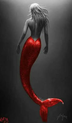 a woman with long hair in a red mermaid tail