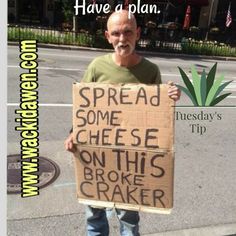 a man holding a sign that says, have a plan spread some cheese on this broke cracker