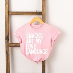 Looking for a cute tee for your kids? We have the perfect Snacks Are My Love Language graphic tee addition to their closet! Also available in youth tees. Perfect Snacks, Minimalist Tshirt, Beautiful Crafts, My Love Language, Love Language, Wardrobe Inspiration, Toddler Tees, Love Languages, Pink Shirt