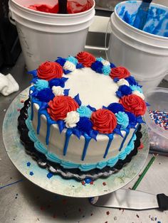 a cake with red, white and blue frosting sitting on top of a table