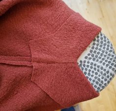 a close up of a piece of clothing on a wooden floor