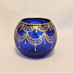 a blue vase with gold decorations on it