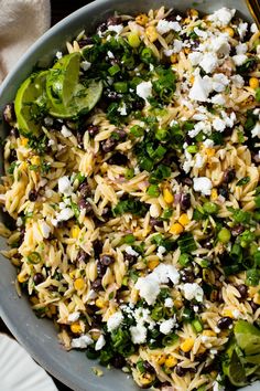 a bowl filled with rice and vegetables on top of a table