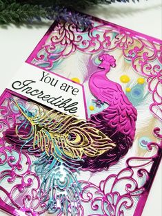 a card with a purple peacock on it