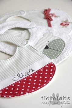 a baby bib with an elephant applique on it