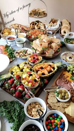 a table filled with many different types of food and snacks on it's trays