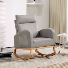 a grey rocking chair in a living room