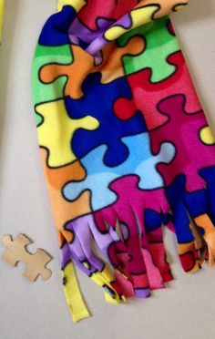 a multicolored piece of cloth next to a puzzle piece