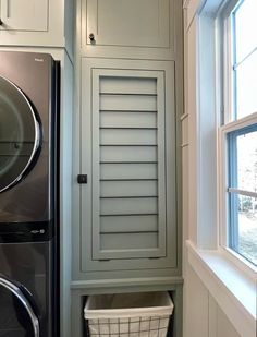 a washer and dryer sitting next to each other in a room with white walls