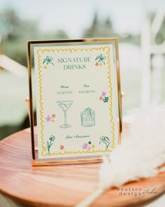 a sign that is sitting on top of a wooden table next to a white feather