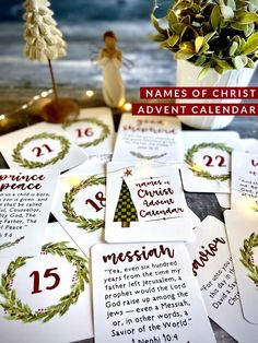 the names of christmas cards are on display in front of a vase filled with greenery