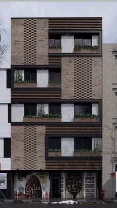 an apartment building with many windows and plants on the balconies