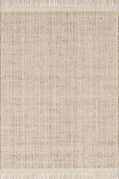 a beige rug with fringes on top