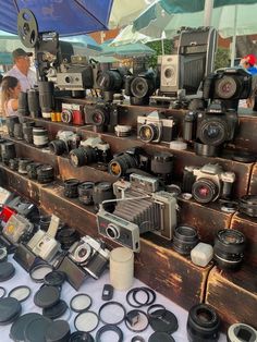 many cameras are on display at an outdoor market