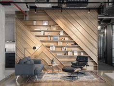 an office with wooden paneling and black leather chairs in front of a bookshelf