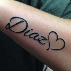 a person with a tattoo on their arm has the word love written in cursive letters