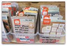 several plastic containers with different types of cards and tags in them for sale on a store shelf