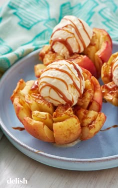 apples covered in ice cream and drizzled with caramel on a plate