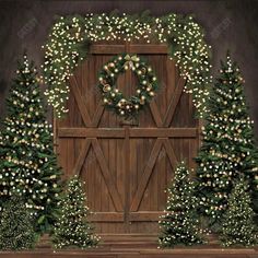 an image of christmas trees and wreaths in front of a wooden door with lights