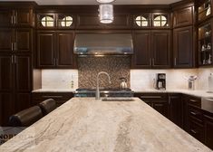 a kitchen with marble counter tops and wooden cabinets