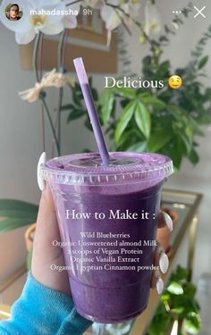 a person holding up a purple smoothie in front of a plant with the caption delicious how to make it?