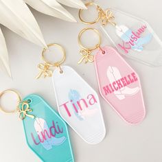 three personalized keychains with the names of different countries