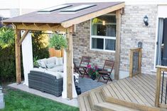 an outdoor living area with patio furniture and wooden steps leading up to the front door