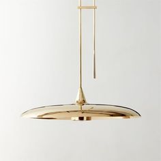 a gold pendant light hanging from a ceiling