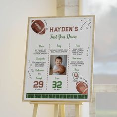 a sign with a photo of a baby holding a football