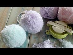 several balls of yarn are sitting on a table next to scissors and ball cutters