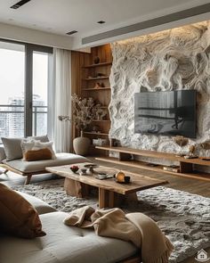 a living room filled with furniture and a flat screen tv mounted on a wall next to a window