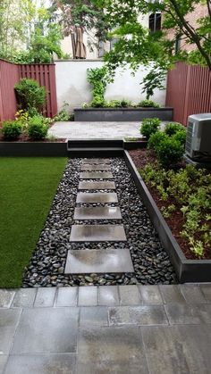 an outdoor garden with grass and stepping stones