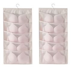 two white hanging storage bags filled with breast bras and one is open to reveal the bras