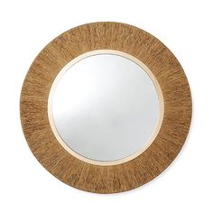 a round wooden mirror on a white wall