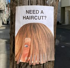 a sign posted on a telephone pole that says, need a haircut? with an image of a woman's head