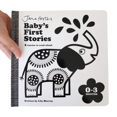 a person holding up a book with an elephant on it's cover and the title, baby's first stories