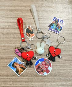 several different key chains with pictures and magnets on them sitting on top of a table