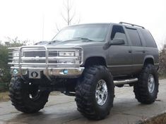 a large gray truck parked on top of a sidewalk