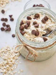 a jar filled with oatmeal and chocolate chips on top of a table