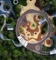 an aerial view of a playground in the middle of a park with lots of trees